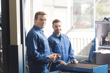 Handsome professional mechanics getting ready for a checkup