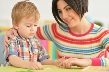Naklejka premium Young mother playing with son