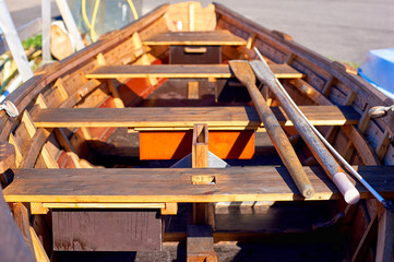 Wooden boat with oars