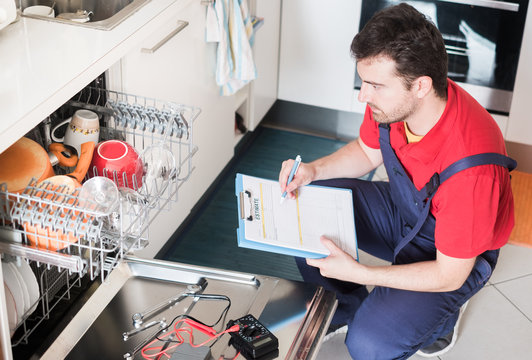 Worker estimating cost for broken dishwasher