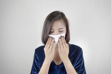 Woman having flu and holding a tissue