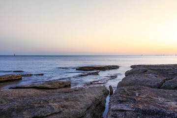 long exposure sunset beach rocks
