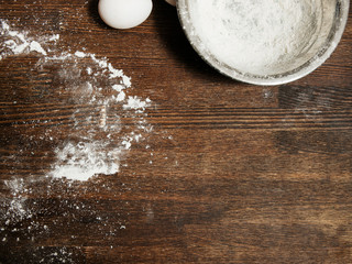 Dirty cooking table with flour and bowl, eggs food concept, top view copy space