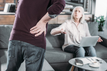 cropped shot of man suffering from strong back pain