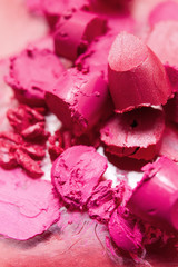Lipstick pink smeared samples closeup. Cosmetics commercial, creative advertising, bright colors. Beautiful style, glamorous magazine, beauty concept