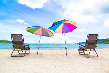 Chairs and umbrella in  beach - tropical holiday.