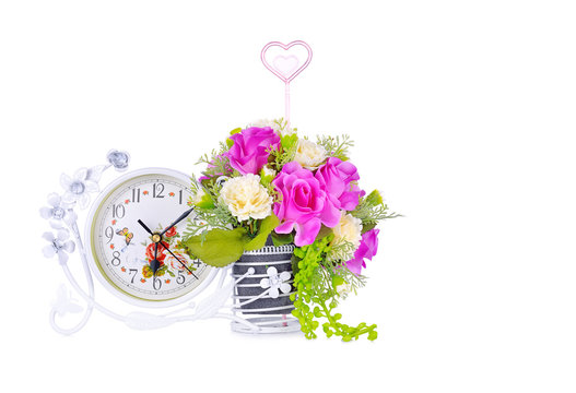 Flower vases and clock tell a significant time on a white background.