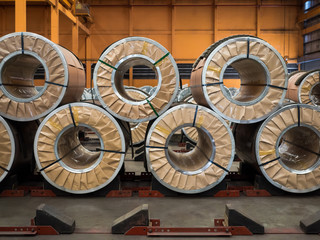 Steel coil in paper packaging are stacking in warehouse.