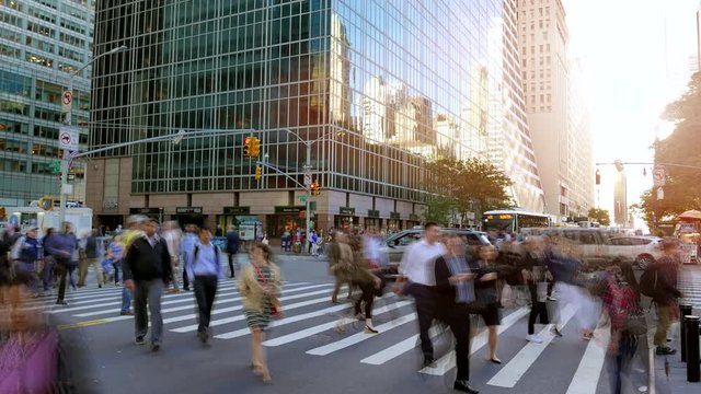 crowd of people walking in the city commuting through business district