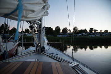 View of a sailboat near a campsite during sunset