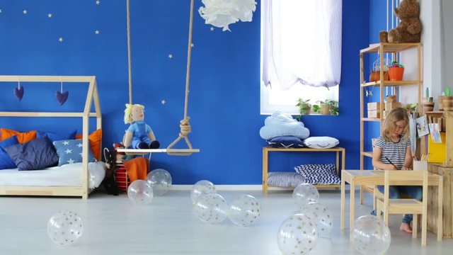 Blue Kids Room With Wooden Simple Furniture
