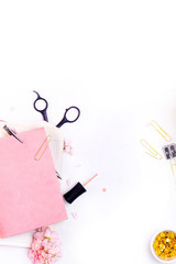 Workplace mockup with pink leather notebook, glasses and golden accessories top view. Flat lay with copy space.  Feminine working style concept.