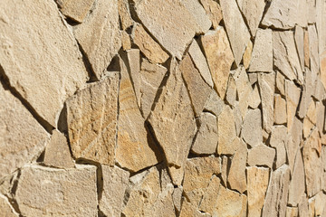 Multi-colored and multi-sized, orange and brown rock wall grunge texture background.