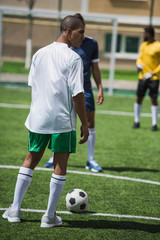 group of soccer players during soccer match on pitch