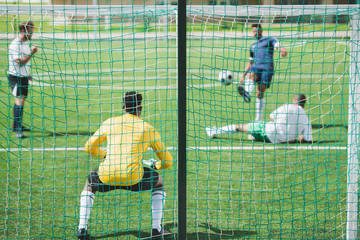 group of soccer players during soccer match on pitch