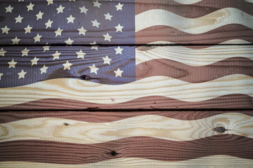 Obraz premium Vintage American Flag painted on an aged, weathered rustic wooden Background.