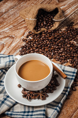 coffee cup with coffee beans,on wood table.