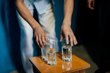 Many glasses on a table with alcohol and without