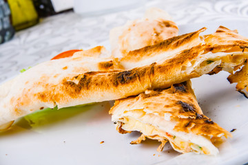 Roasted rolls of bread lavash filled with cheese and herbs