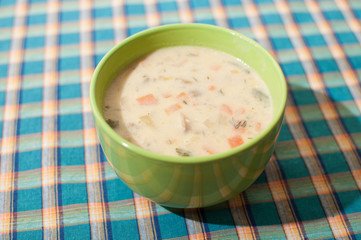 Mushroom cream soup in green bowl, top view