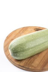 Fresh whole zucchini on the wooden kitchen board