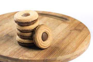Round chocolate cookies on the wooden board