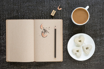 Coffee, diary, pencil and heart-shaped cookies