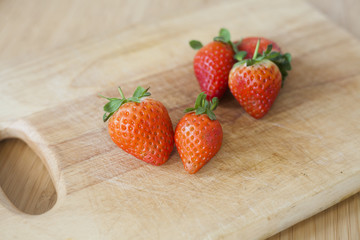 fresh strawberries on a chopping board