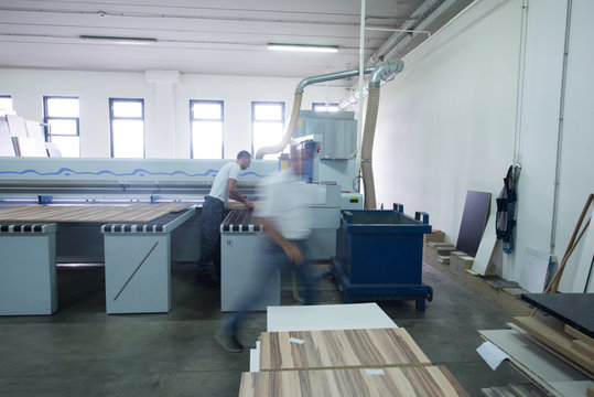 workers in a factory of wooden furniture