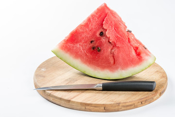 Sliced watermelon on the wooden board with knife