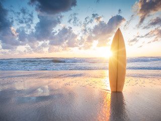 Surfboard on the beach at sunset - 163938223