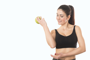 Young caucasian woman holding apple. Fitness and diet concept. Healthy lifestyle