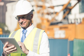 Construction manager controlling building site and tablet device