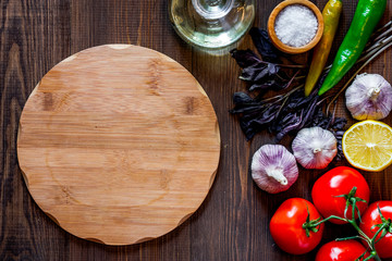 Mockup for menu. Cutting board and vegetables on wooden table background top view