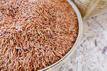 Red rice grains in bamboo basket