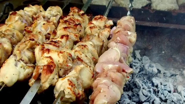 meat roasting on skewers in brazier outdoors