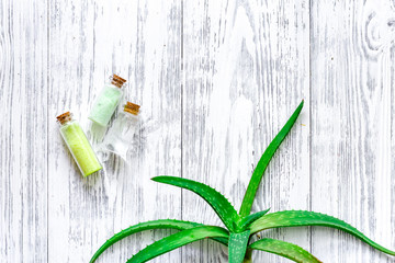 Skin care. Aloe vera leafs and spa salt on wooden background top view copyspace