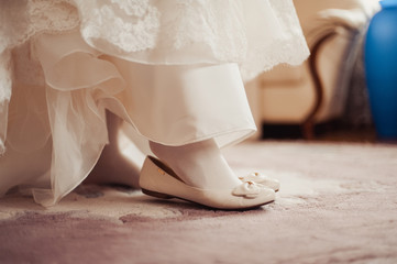 Fototapeta na wymiar Bride Putting On Wedding Shoes