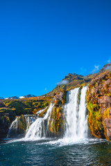 Wonderful waterfal Kirkjufellsfossl in Iceland in Autumn colors