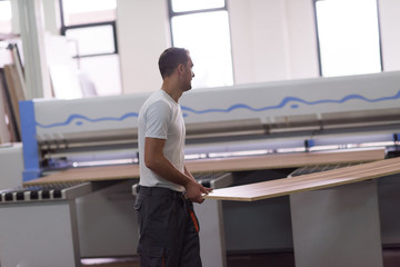 Fototapeta premium worker in a factory of wooden furniture