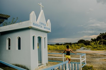 Small Church and girl in sunset