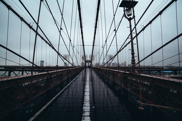 Brooklyn Bridge: Viewed down the center against NYC skyline on a rainy day