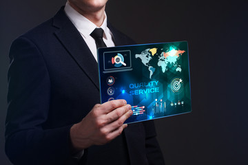 Business, Technology, Internet and network concept. Young businessman working on a virtual screen of the future and sees the inscription: Quality service