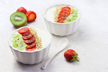 Raw vegan breakfast bowl with strawberry and kiwi. 