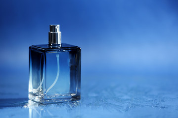 Bottle of modern male perfume on color background