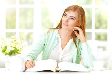 young woman reading book