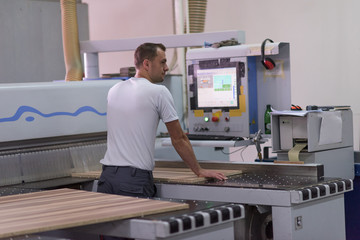 worker in a factory of wooden furniture