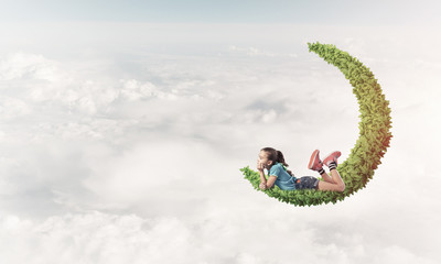 Concept of careless happy childhood with girl dreaming about som