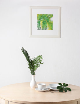 Table setting with green tropical leaves in cafe