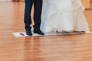 Fototapeta premium The couple is standing on an embroidered towel